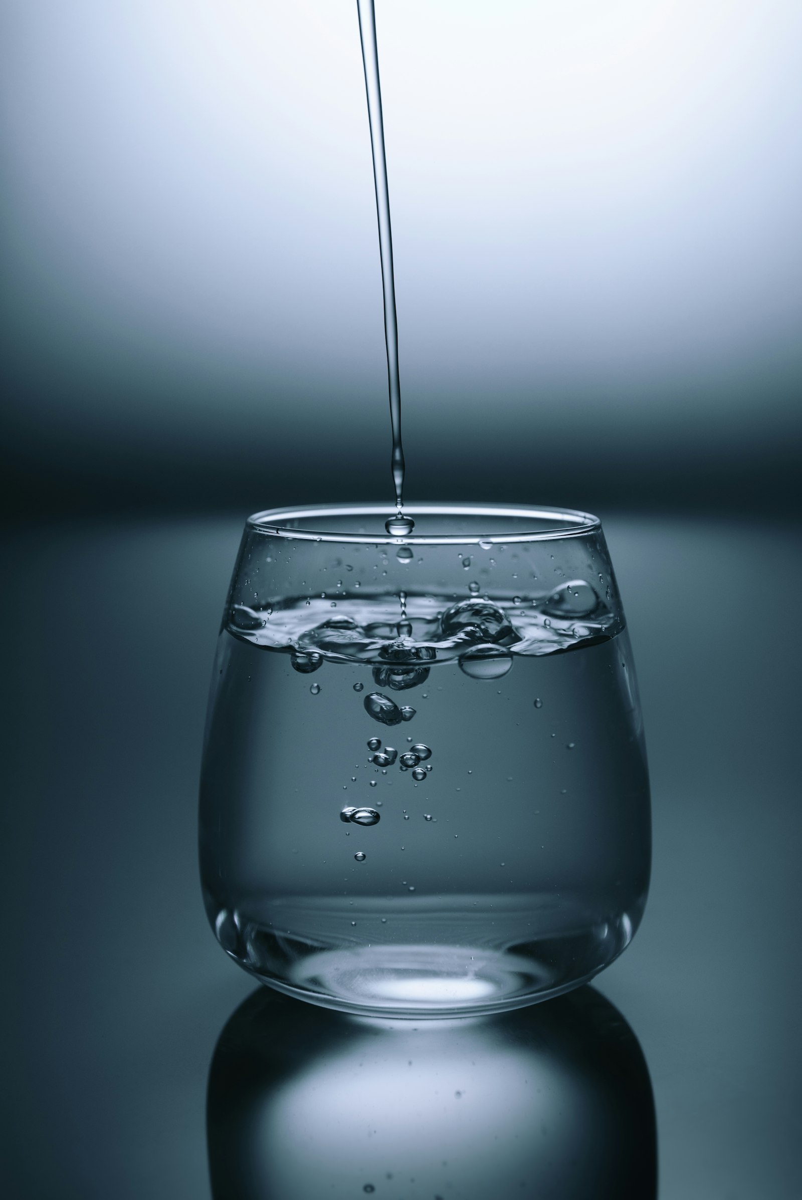 Clear water pouring into a drinking glass